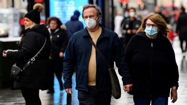 Shoppers wear protective face masks as they walk on Oxford Street, as rules on wearing face coverings in some settings in England are relaxed, amid the spread of the coro<em></em>navirus disease (COVID-19) pandemic, in London, Britain, on January 27, 2022. (Reuters)