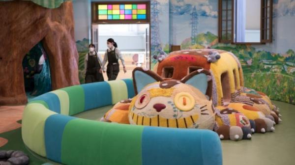 A display of the Cat Bus from the film 'My Neighbor Totoro', in the Ghibli's Grand Warehouse area